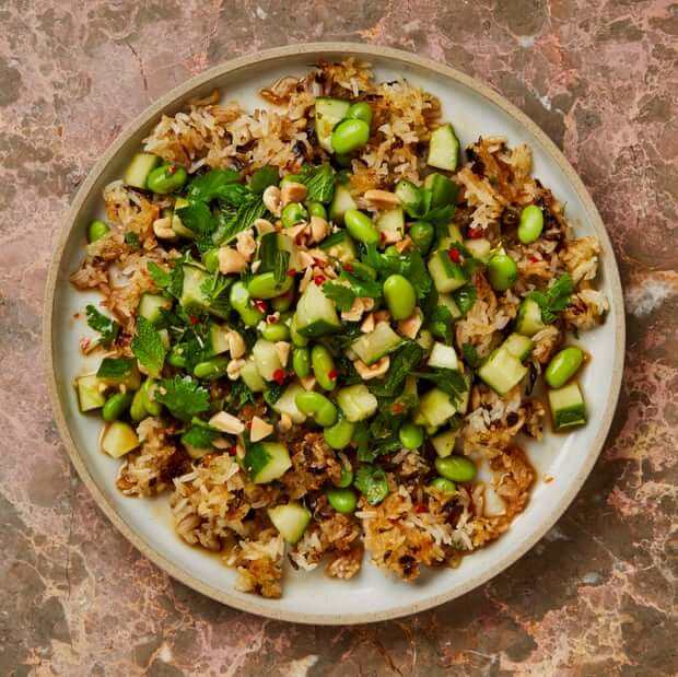 Crispy fried rice with cucumber, peanut and herb salad