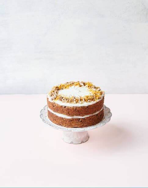 Parsnip, orange and nut muffins with cream cheese frosted topping